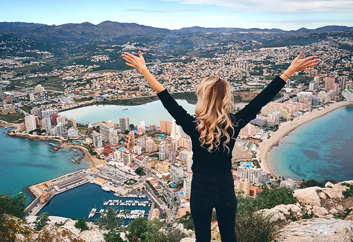 Excursionista observando Calpe desde el Peñón de Ifach